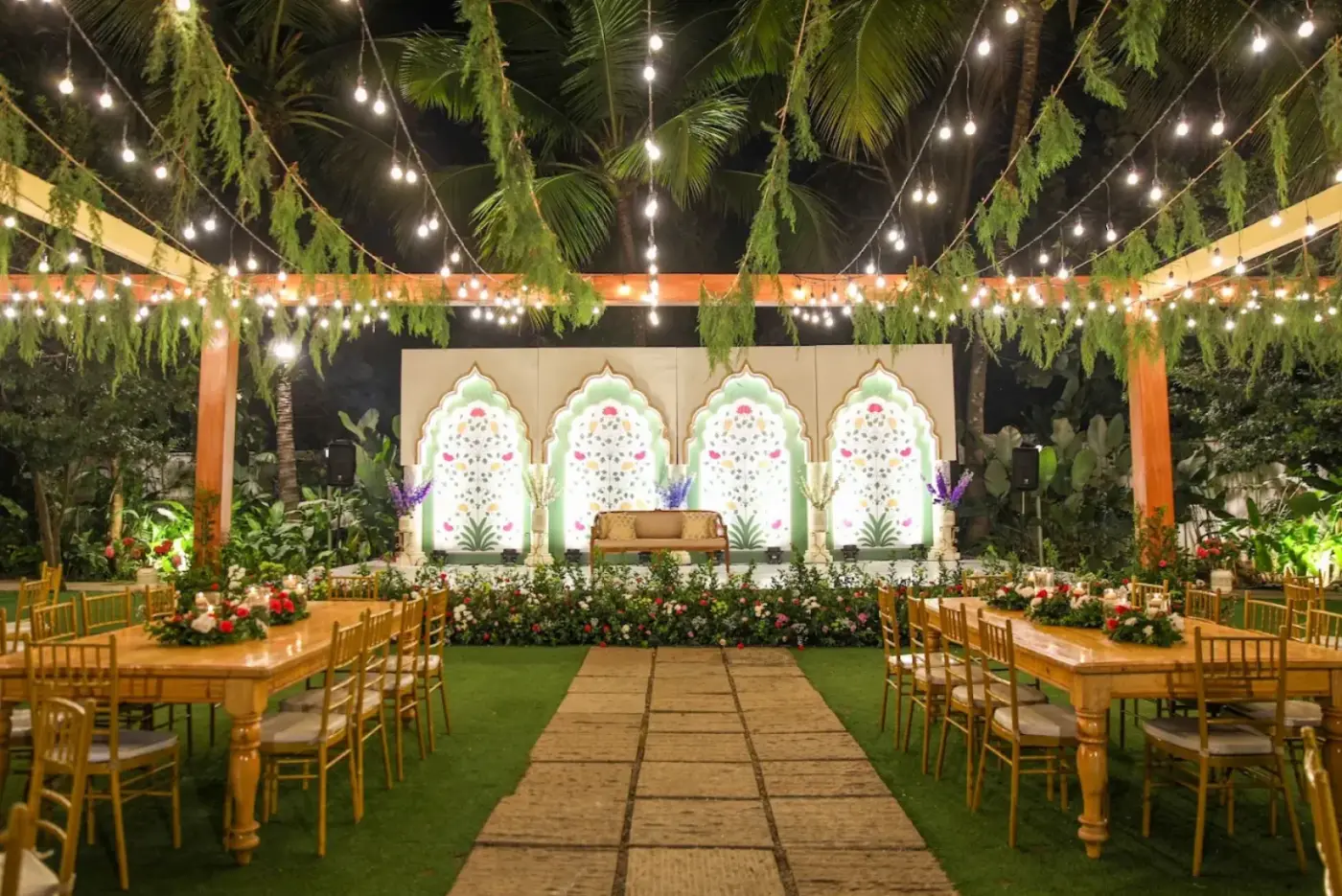 An outdoor wedding venue lit with string lights